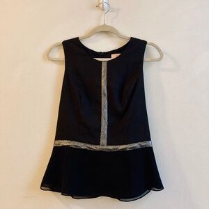 Black blouse, silver detail, sleeveless fitted top with flared bottom, zip back